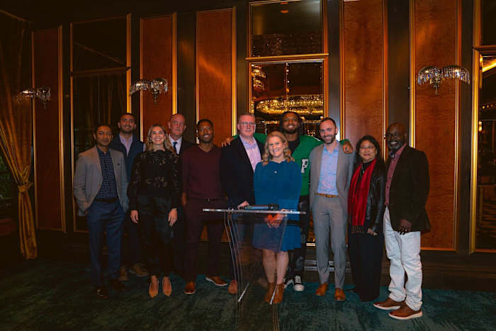 Damar Hamlin poses with a group of dinner attendees